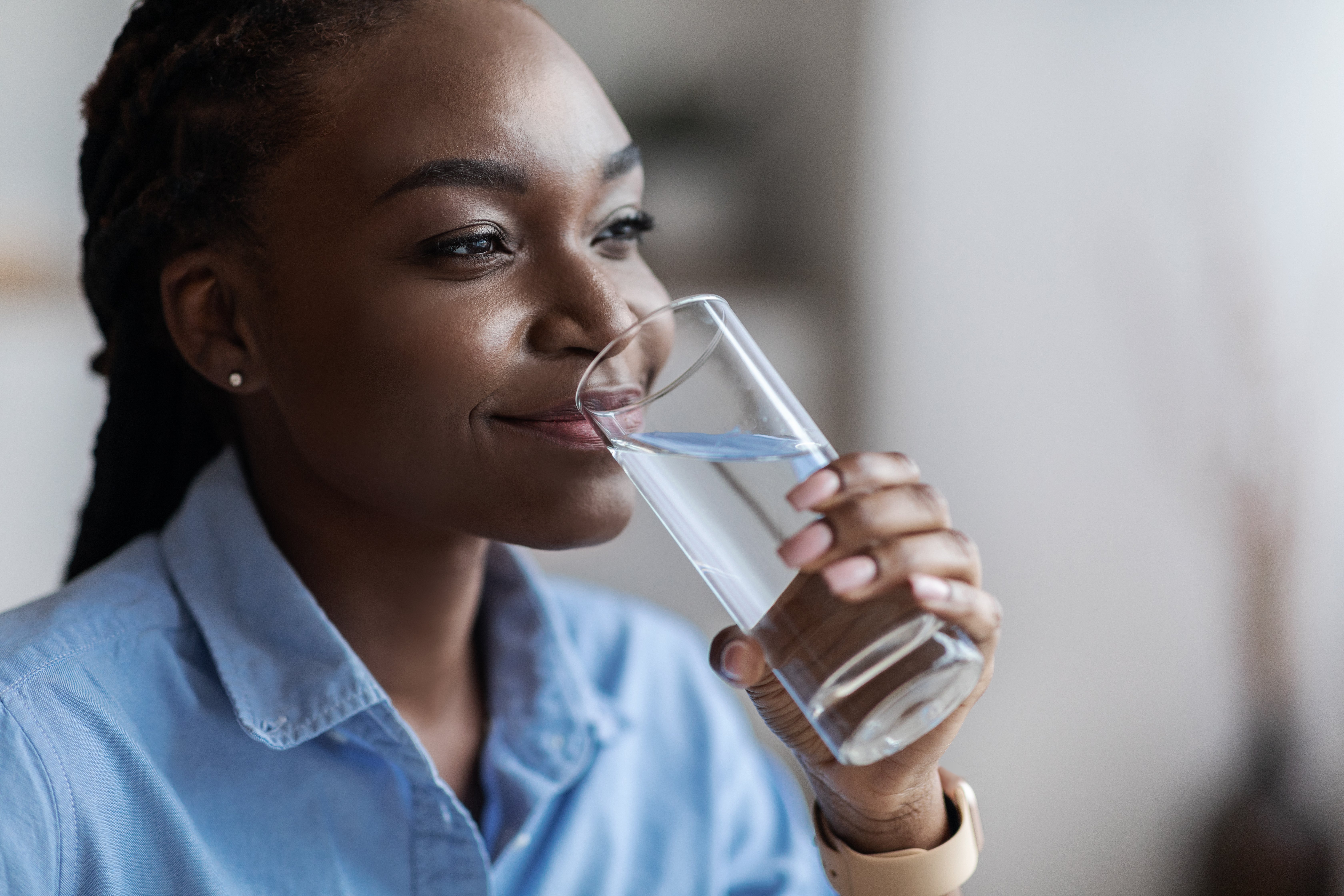 A woman drinking clean, purified water