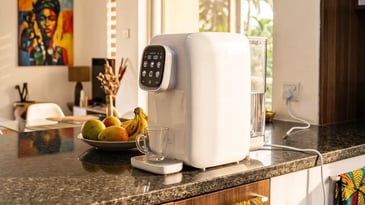 Compact countertop water purifier on a kitchen counter in a Lagos rental apartment