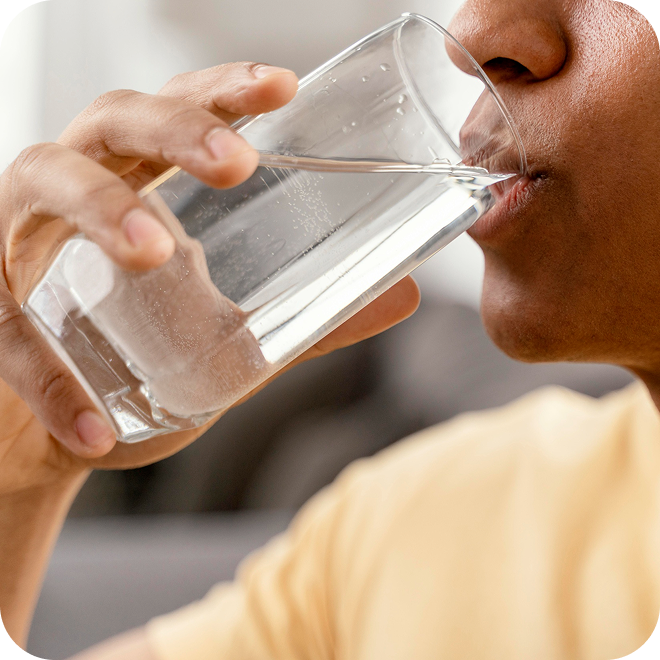 Image of a woman drinking clean, purified water from a glass