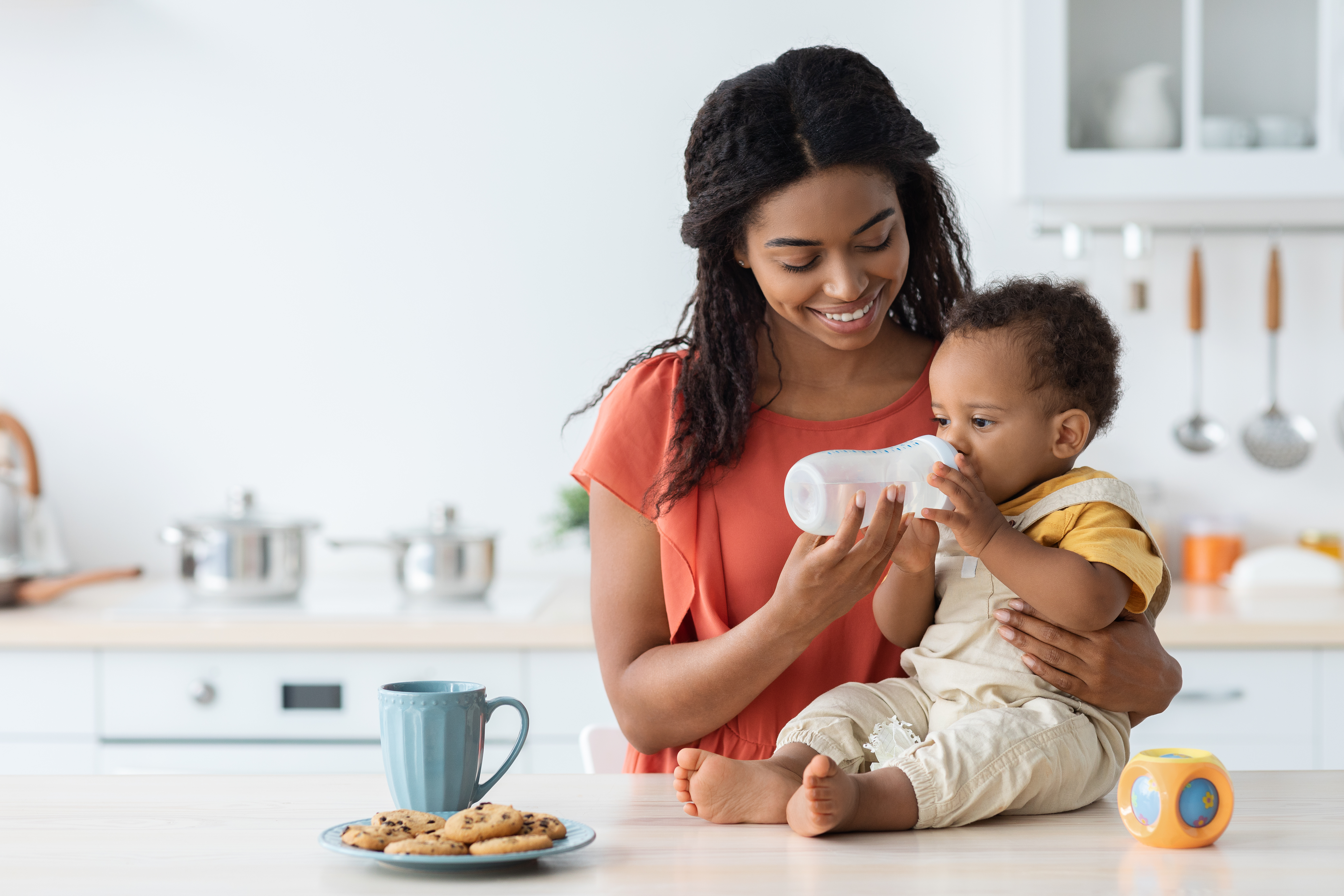 Image of a mother feeding her child clean, purified water