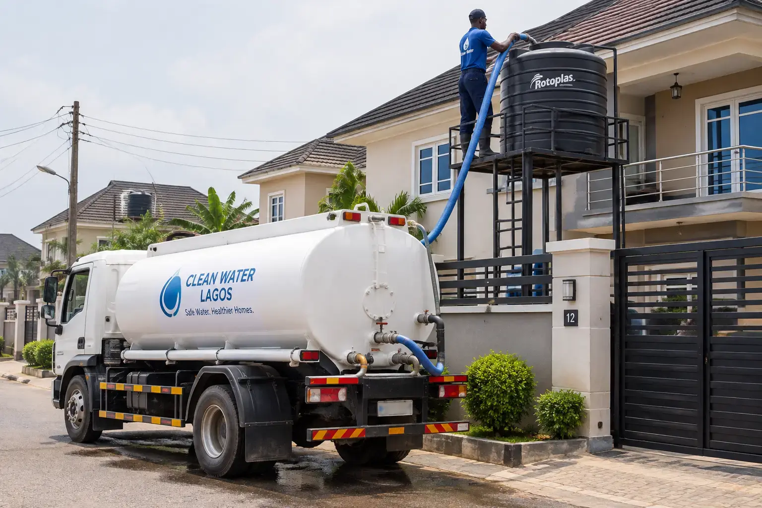 Water tanker delivering to a residential overhead tank in a Lagos estate