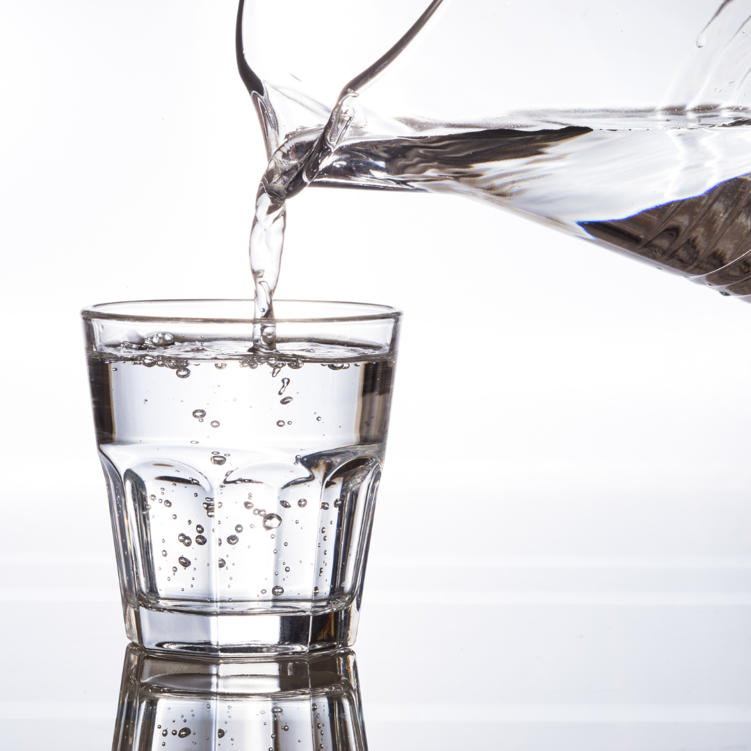 Image of purified water being poured into a glass cup
